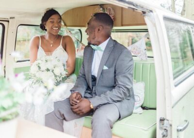 bride and groom in campervan wedding car