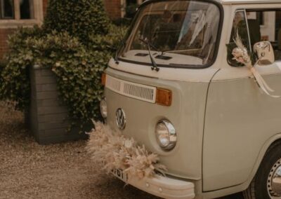 classic campervan wedding car with flowers surrey